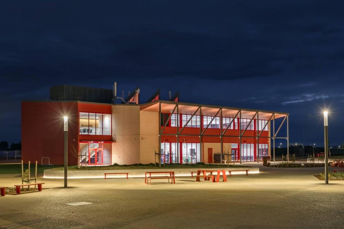 Community centre lit up at dusk in Melton West, Victoria