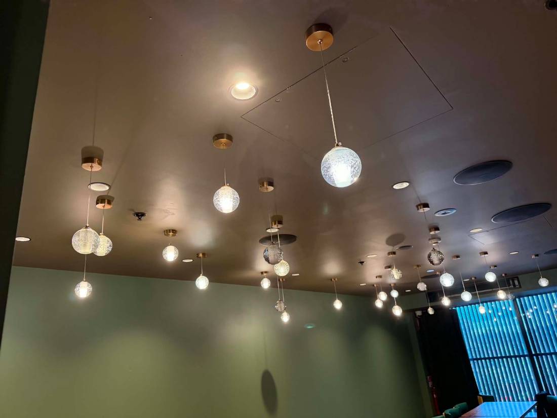 Cluster of glass globe pendant lights installed over a feature area by DTW Electrical