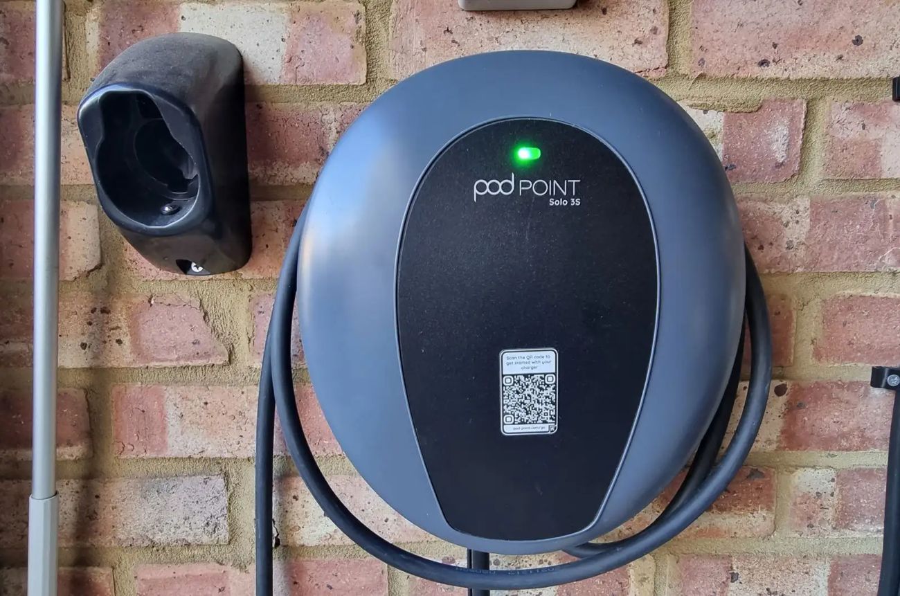 Home EV charger mounted on a brick wall