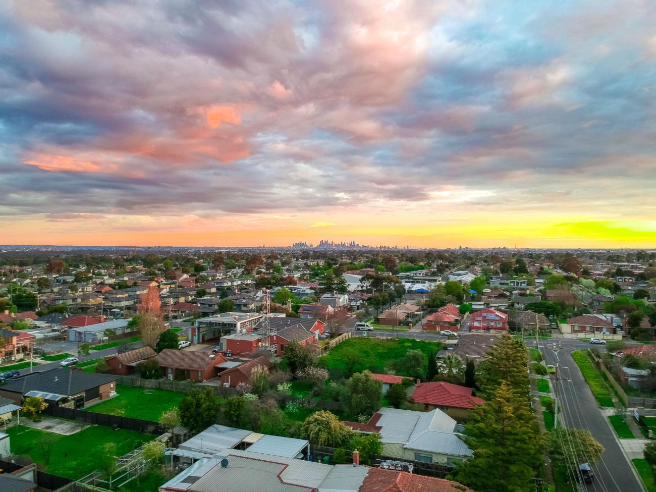 Aerial view of Sydenham at sunset with Melbourne skyline